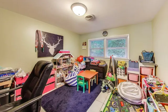 a bedroom with furniture and a fan