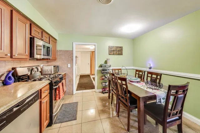 a view of a dining room with furniture and a kitchen