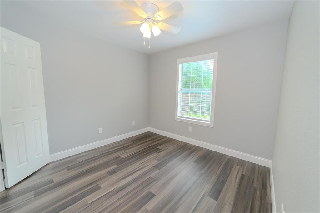 809 Wilcox Street McKinney, TX 75069 - Photo 19 of 26 Unfurnished room with dark wood-style floors and ceiling fan