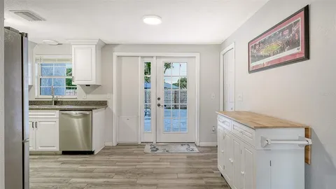 a room with white cabinets and sink