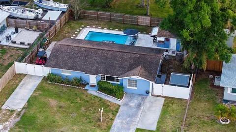 an aerial view of a house with swimming pool garden and patio