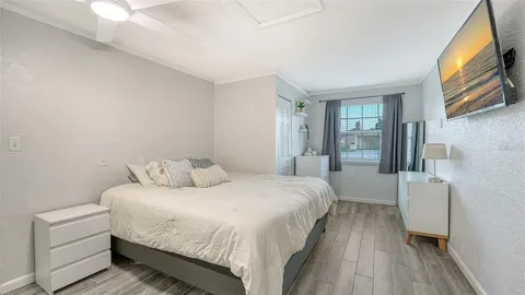 a bedroom with a bed and a large window