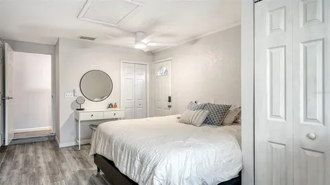 a bedroom with a bed and a mirror