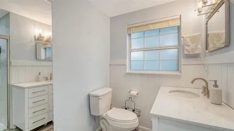 a bathroom with a sink toilet and a mirror