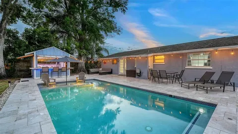 an outdoor space with swimming pool and furniture