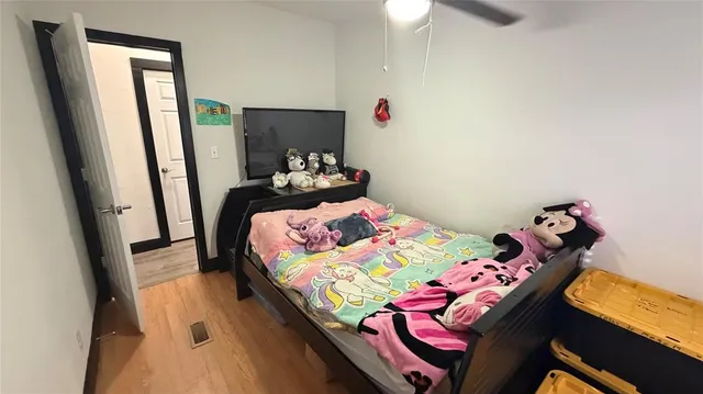 a bedroom with a bed and a dresser