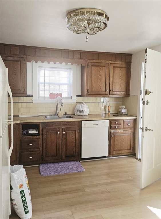 9 Howe Avenue Shrewsbury, MA 01545 - Photo 8 of 9 a kitchen with a stove a sink a refrigerator and cabinets