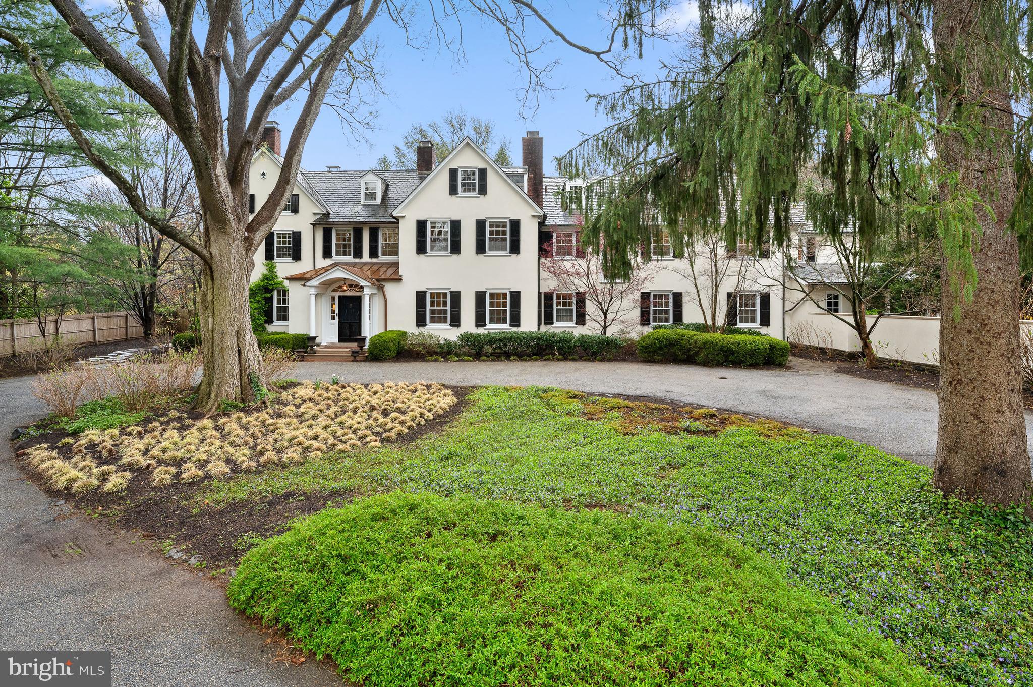 1814-1820 Old Gulph Road Villanova, PA 19085 - Photo 1 of 1 a front view of a house with a garden and trees