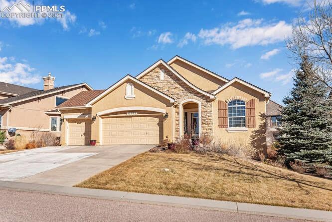 13873 Windy Oaks Road Colorado Springs, CO 80921 - Photo 1 of 28 a front view of a house with a yard