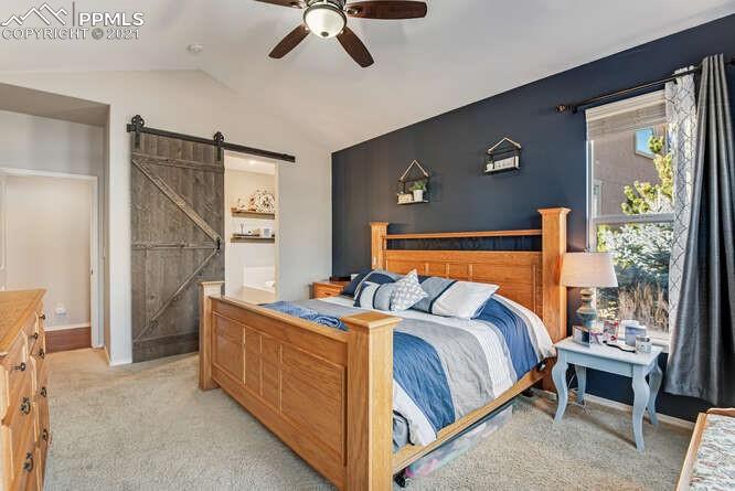 13873 Windy Oaks Road Colorado Springs, CO 80921 - Photo 17 of 28 a bed room with a bed and a balcony
