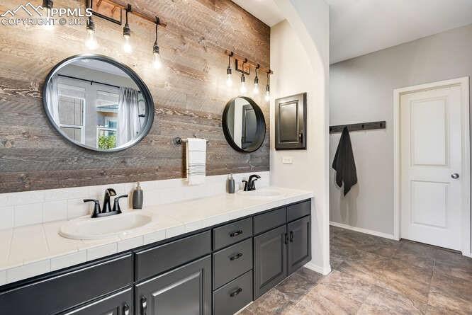 13873 Windy Oaks Road Colorado Springs, CO 80921 - Photo 18 of 28 a bathroom with a granite countertop double vanity sink and a mirror