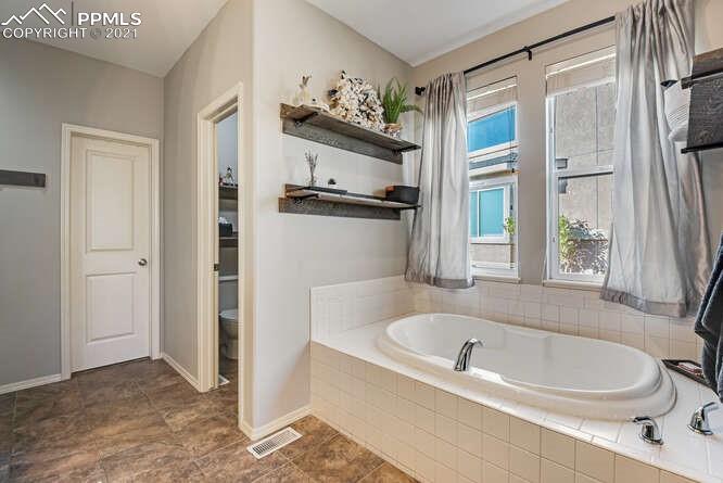 13873 Windy Oaks Road Colorado Springs, CO 80921 - Photo 20 of 28 a bathroom with a bathtub and a shower