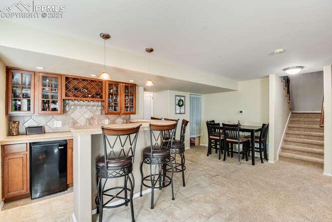 13873 Windy Oaks Road Colorado Springs, CO 80921 - Photo 24 of 28 a view of a dining room with furniture and chandelier