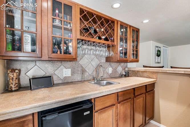 13873 Windy Oaks Road Colorado Springs, CO 80921 - Photo 25 of 28 a kitchen with a sink and cabinets