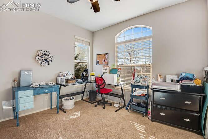 13873 Windy Oaks Road Colorado Springs, CO 80921 - Photo 6 of 28 a view of a workspace with furniture and a window