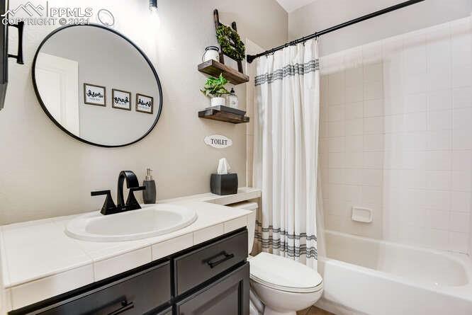 13873 Windy Oaks Road Colorado Springs, CO 80921 - Photo 7 of 28 a bathroom with a sink a toilet and a mirror