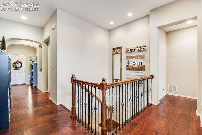 13873 Windy Oaks Road Colorado Springs, CO 80921 - Photo 8 of 28 a view of a hallway with wooden floor