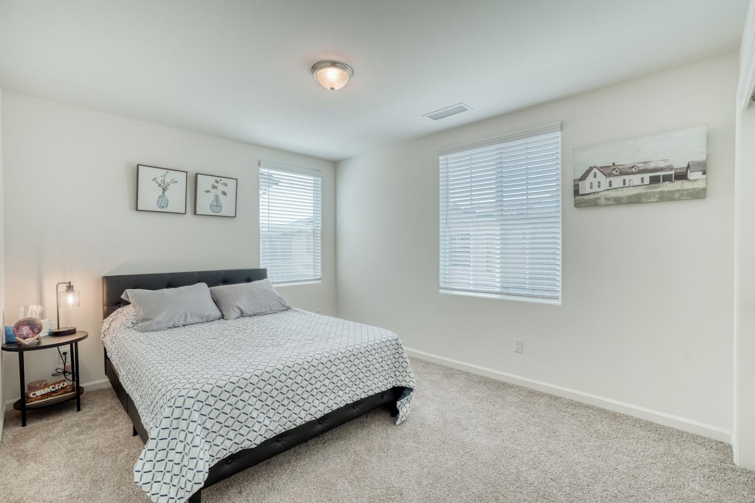 933 Winchell Way West Madera, CA 93636 - Photo 15 of 29 a bedroom with a bed and a night stand