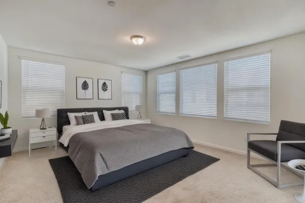 a bedroom with a bed and a couch