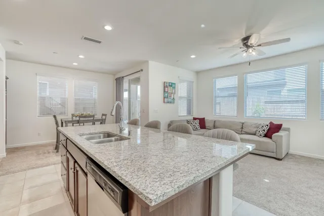 a view of kitchen island a granite countertop living room kitchen island furniture and a window