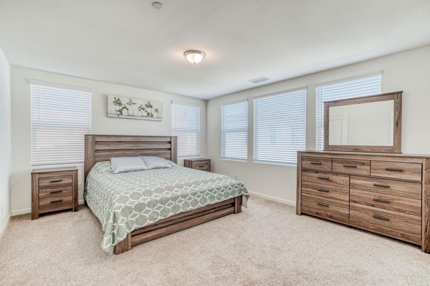 933 Winchell Way West Madera, CA 93636 - Photo 9 of 29 a bedroom with a bed and a dresser