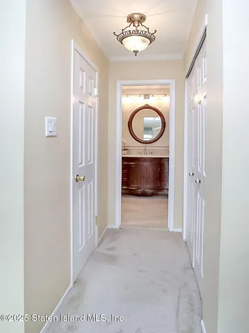 a view of a hallway with a washer and dryer