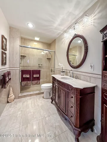 a bathroom with a double vanity sink a mirror and a bathtub