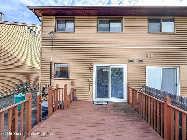 a view of a house with wooden fence