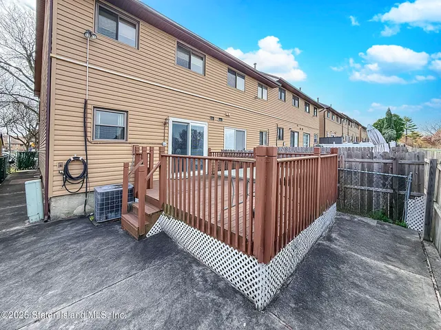 a view of a house with wooden fence