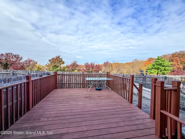 a balcony with wooden floor and city view