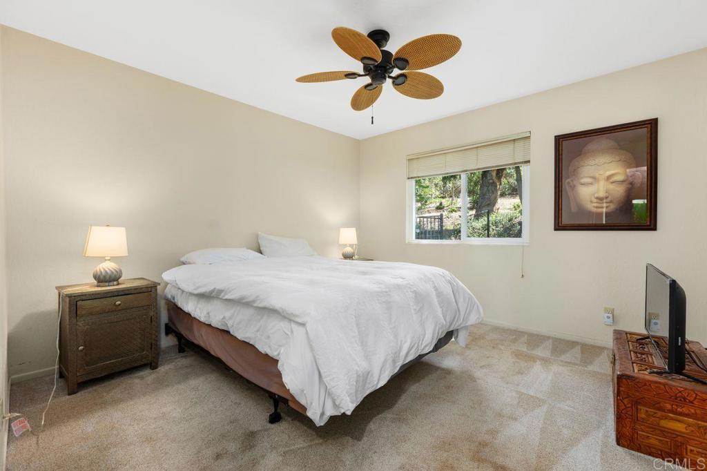 29560 Lilac Road Valley Center, CA 92082 - Photo 22 of 43 a bedroom with a bed and a tv on the dresser