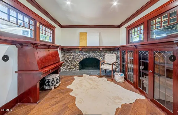 a view of living room kitchen with furniture and fireplace