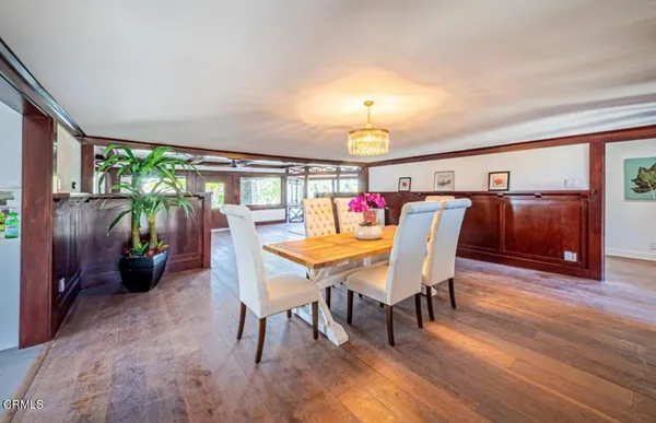a view of a dining room with furniture window and wooden floor