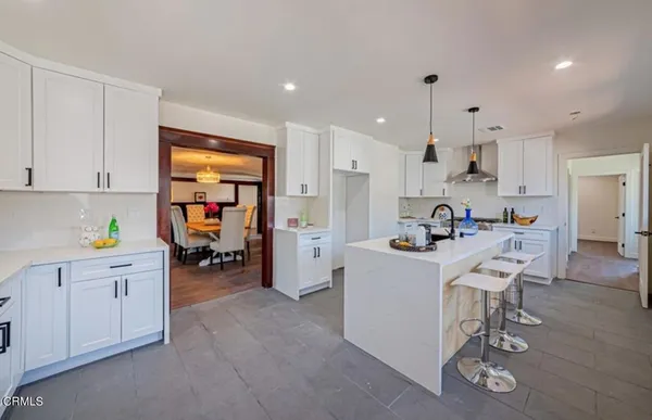 a kitchen with stainless steel appliances kitchen island granite countertop a sink and cabinets
