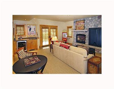 410 Cresta Road Edwards, CO 81632 - Photo 8 of 11 a living room with furniture a fireplace and a flat screen tv