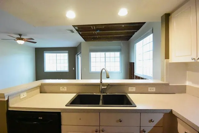 a kitchen that has a sink and a stove in it