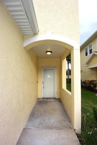 a view of a hallway with wooden walls and entryway