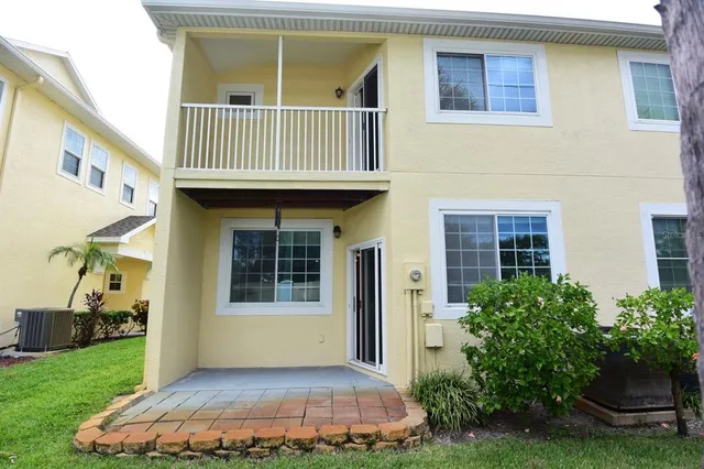 a view of a house with backyard and sitting area