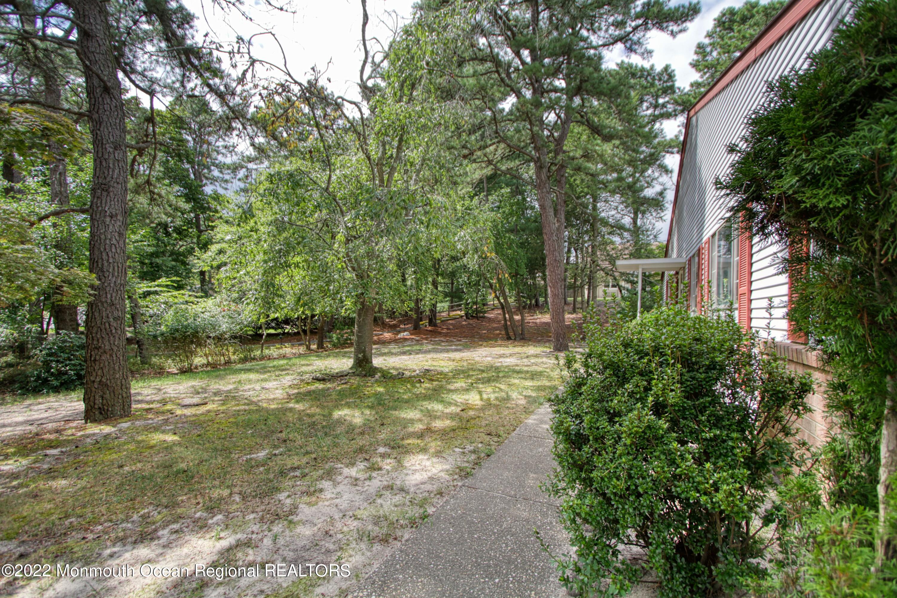 8A Fallbrook Street, Unit A Whiting, NJ 08759 - Photo 15 of 18 a view of a yard with plants and trees