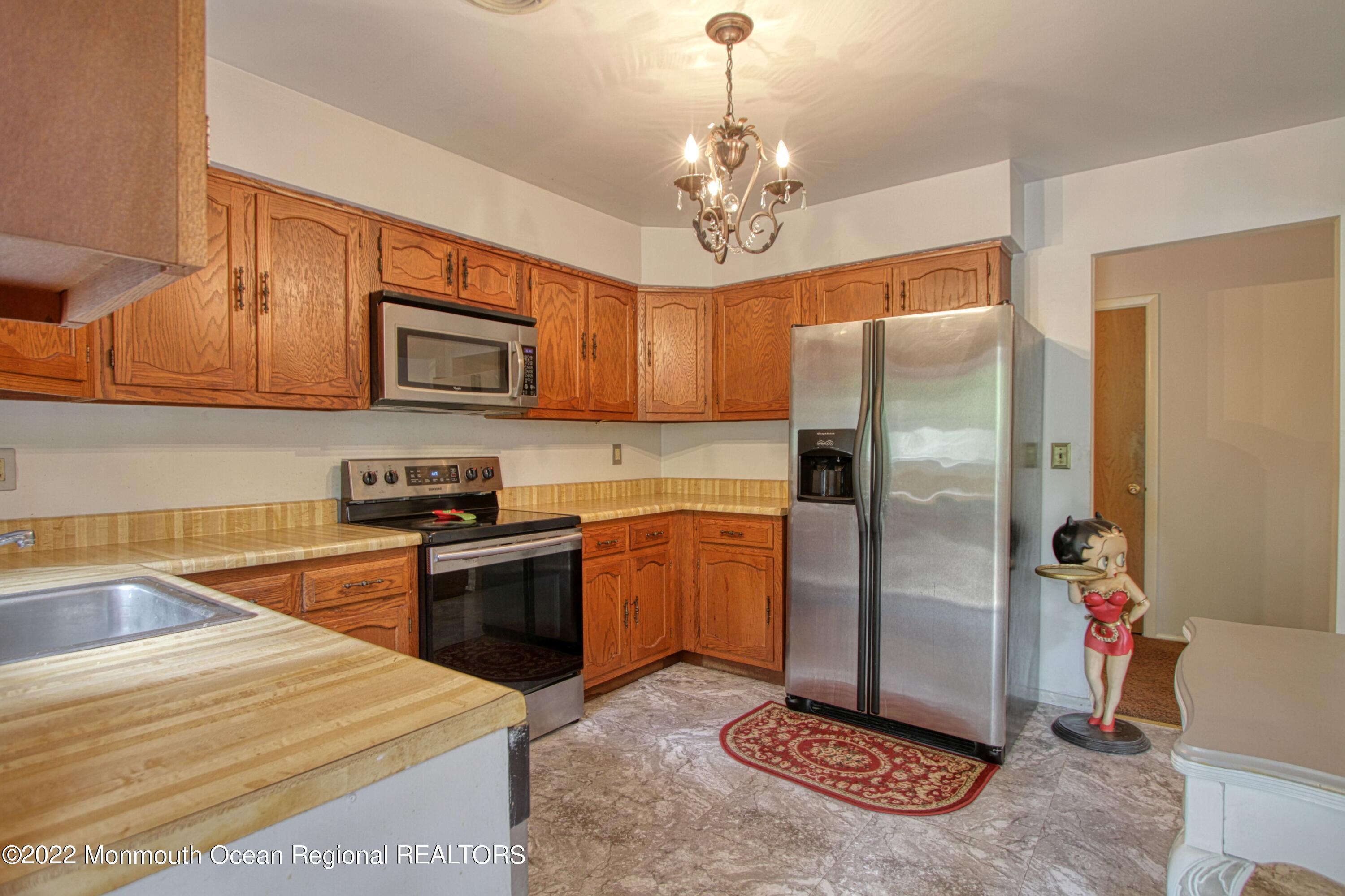 8A Fallbrook Street, Unit A Whiting, NJ 08759 - Photo 3 of 18 a kitchen with stainless steel appliances granite countertop a refrigerator stove and sink