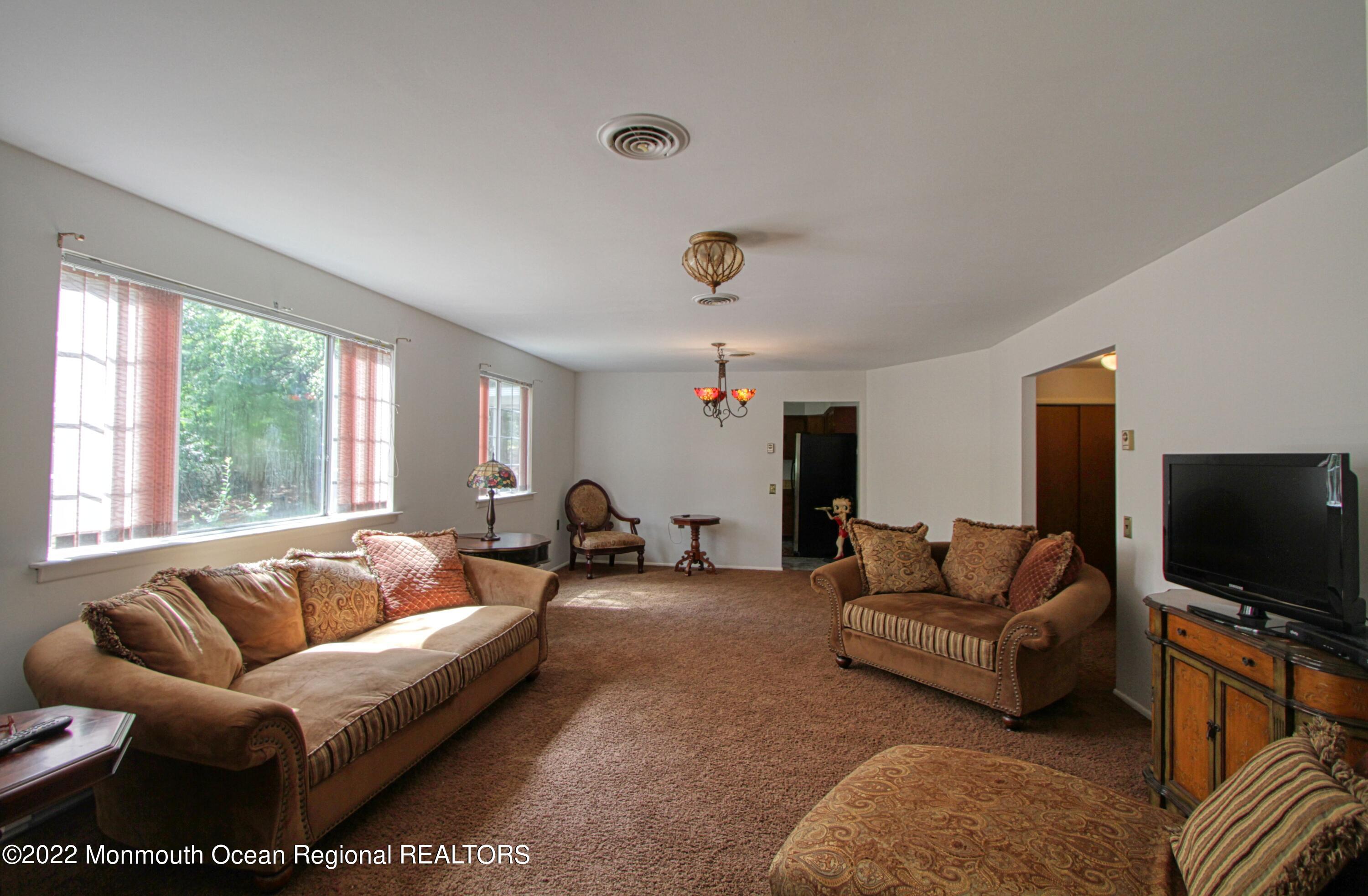 8A Fallbrook Street, Unit A Whiting, NJ 08759 - Photo 6 of 18 a living room with furniture and a flat screen tv