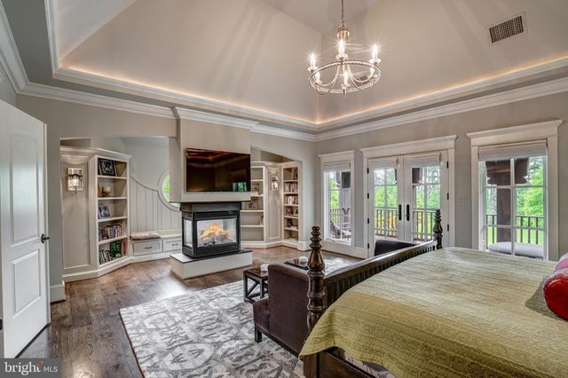 a spacious bedroom with a bed and a television