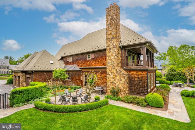 a front view of a house with a garden and plants