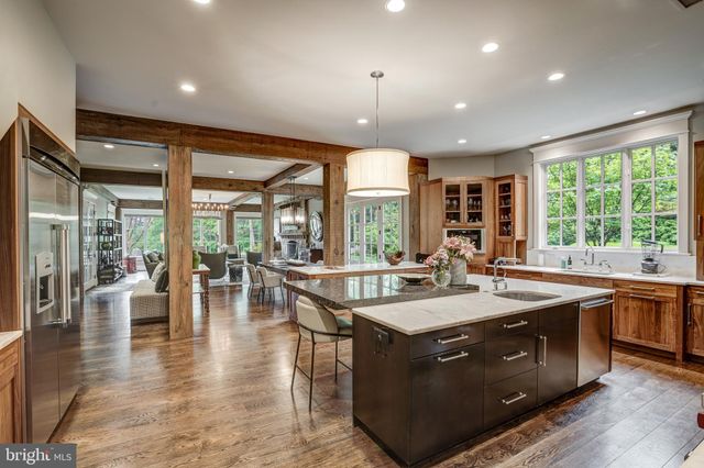 a kitchen with a stove a sink and dishwasher with wooden floor