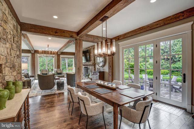 a view of a dining room with furniture large windows and wooden floor