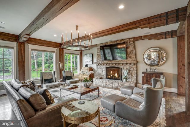 a living room with furniture a large window and a fireplace