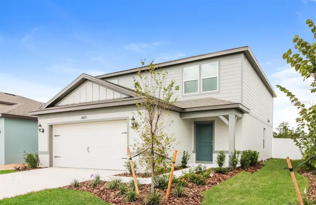 3669 Hornbeam Road Spring Hill, FL 34609 - Photo 2 of 4 a view of a house with a yard and plants