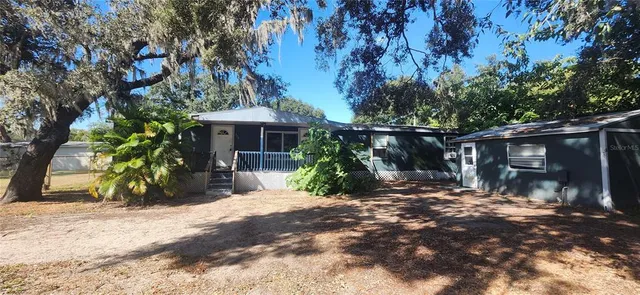 a view of a wooden house with a tree