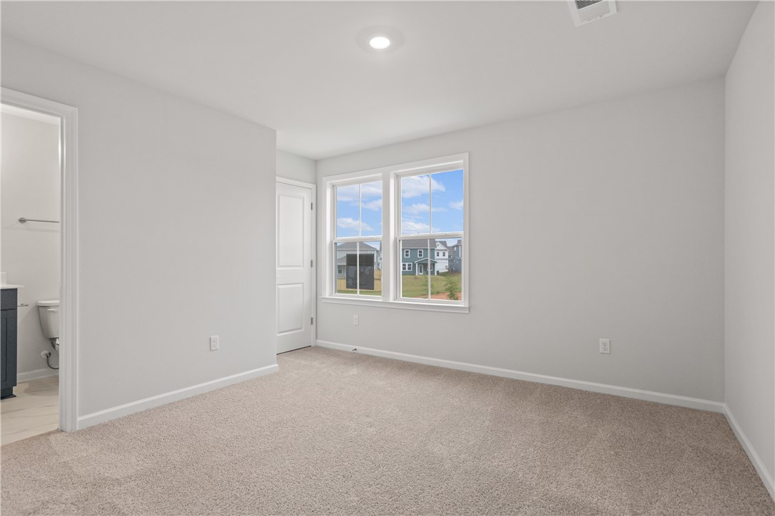 629 Sweetspire Trail, Unit 149 Seneca, SC 29678 - Photo 13 of 30 A spacious, naturally illuminated room featuring plush carpeting and a serene neighborhood view through large windows.