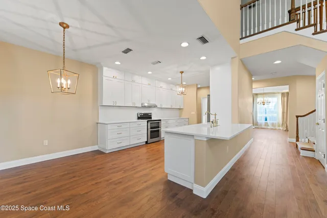a view of staircase with wooden floor and fan